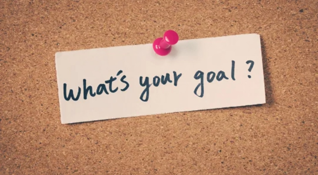 Corkboard with pinned note asking "What's your goal?" symbolizing ADHD goal setting and motivation